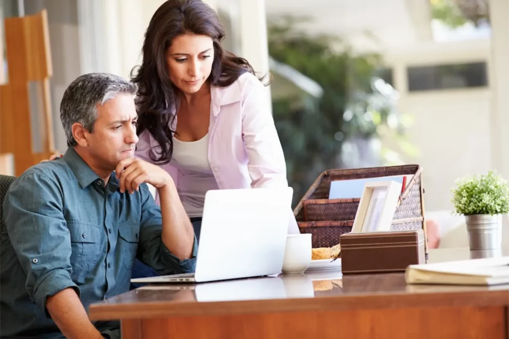ITIN rejection represented by a man and a woman looking at a document.